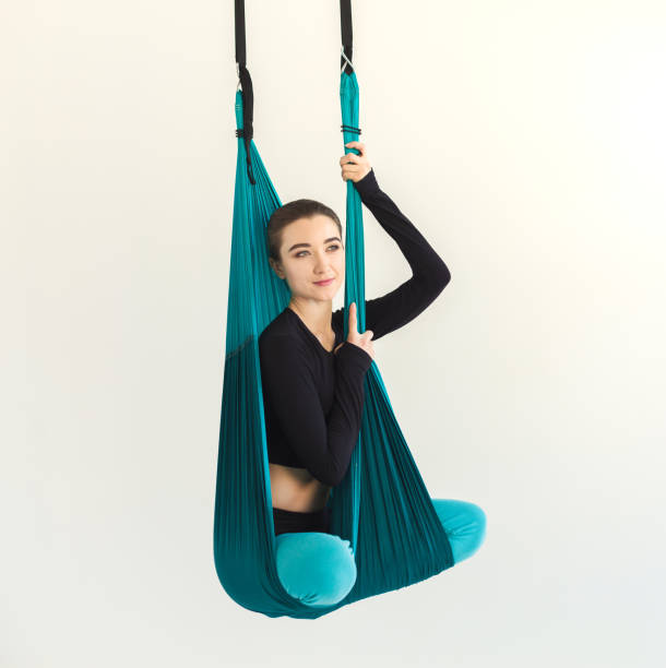 istock Woman practicing fly yoga over white background 980927398