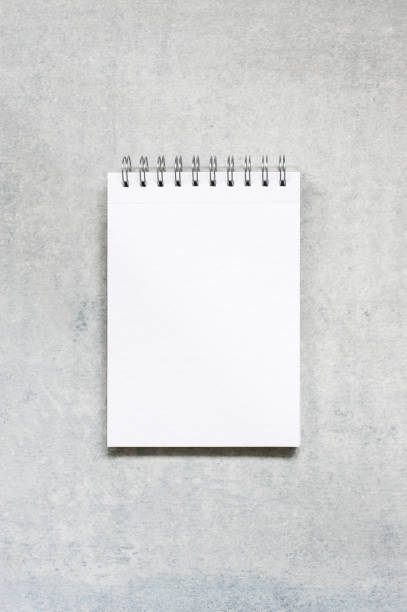 istock Blank sheet of notepad on the textured grey table 980931694