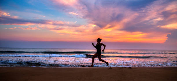 istock Woman running at beach 980931904