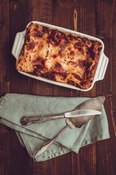 istock Italian Lasagna Bolognese and Mozzarella Cheese on Rustic Dark Wooden Background 980936294