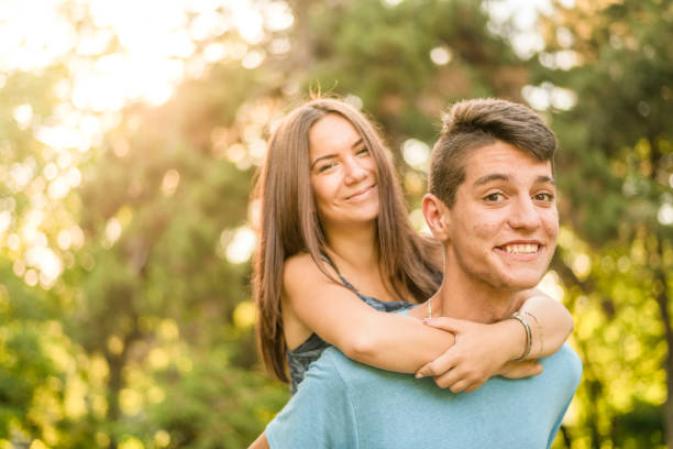 Teenage couple during piggyback ride