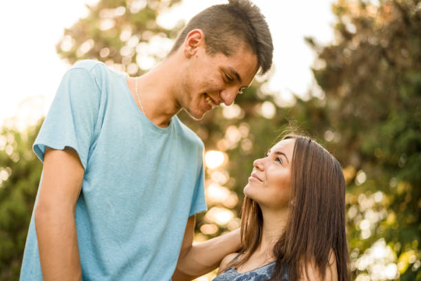 Teenage couple having some quality time in the park stock photo