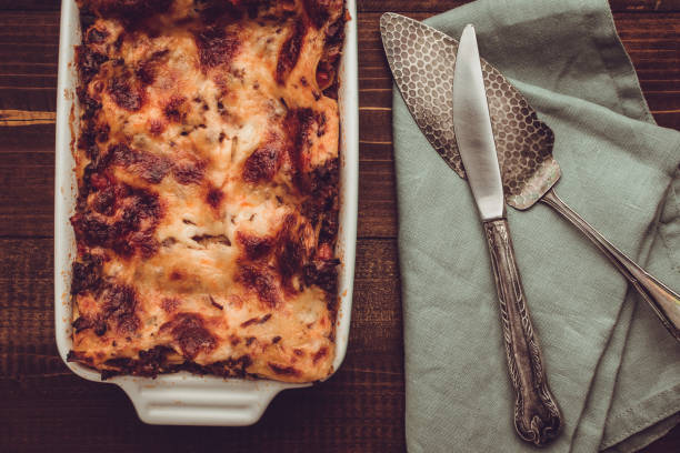 istock Italian Lasagna Bolognese and Mozzarella Cheese on Rustic Dark Wooden Background 980937652