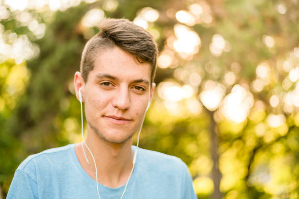Teenager listening to music portrait stock photo