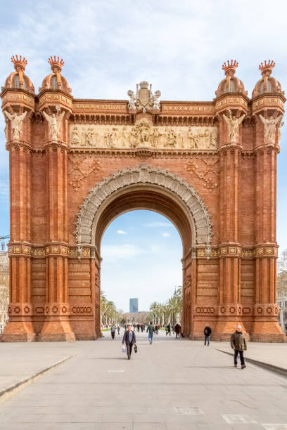 The Arch of Triumph in Barcelona, Spain Barcelona/Spain - March 19, 2015: The Arch of Triumph in Barcelona, Spain on a sunny winter's day with locals out for a stroll. arc de triomf barcelona photos stock pictures, royalty-free photos & images