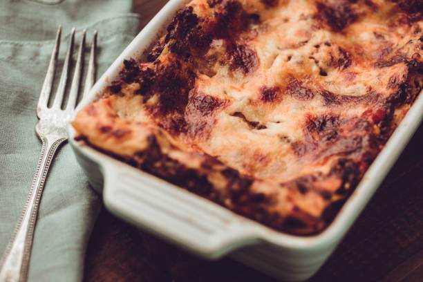 istock Italian Lasagna Bolognese and Mozzarella Cheese on Rustic Dark Wooden Background 980940588