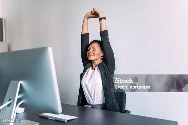 Break At Work Female Office Worker Stretching Hands Stock Photo - Download Image Now