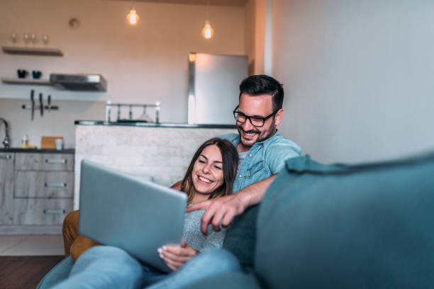 istock Relaxing at home, watching photos on laptop. 980947420