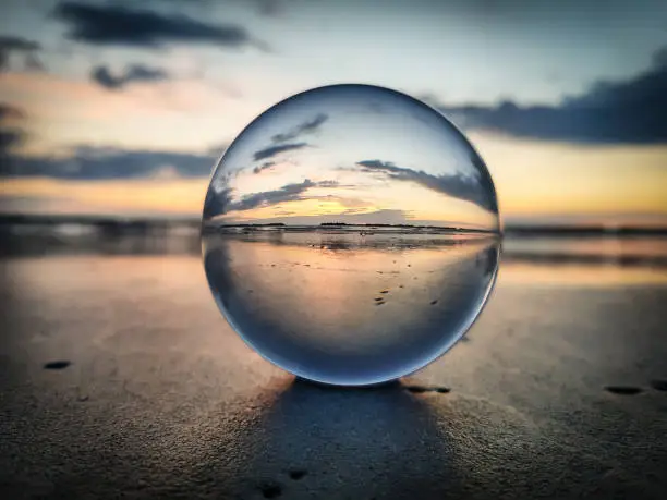 Photo of Watching sunrise throught a lens ball - Riviera Romagnola