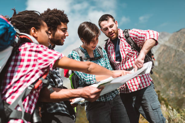 istock friends checking the map on top of mountain 980949656