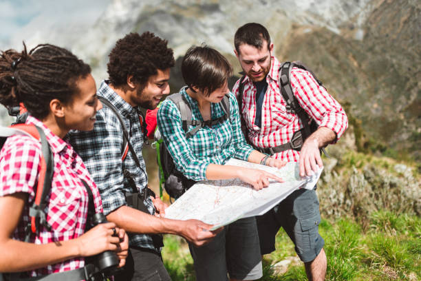 istock friends checking the map on top of mountain 980949866