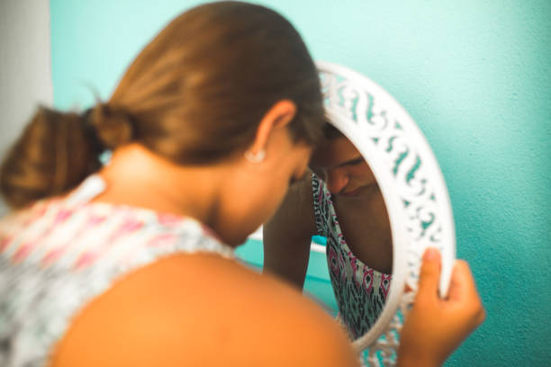 Sad girl in the mirror Sad girl in the mirror low self esteem stock pictures, royalty-free photos & images