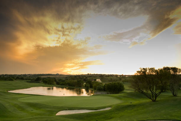 water hazards on a fairway golf course Panoramic view of water hazards on a fairway golf course at sunset country club stock pictures, royalty-free photos & images