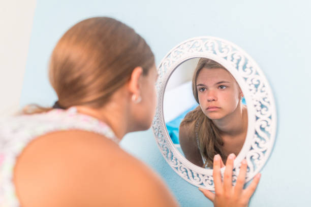istock Sad girl cries in the mirror 980962954