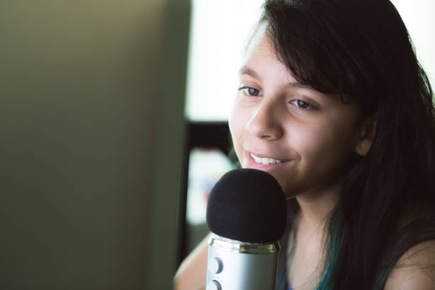istock Teen recording audio on the computer 980968736