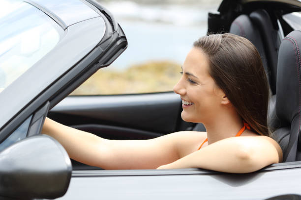 istock Tourist driving a convertible car on summer 980969390