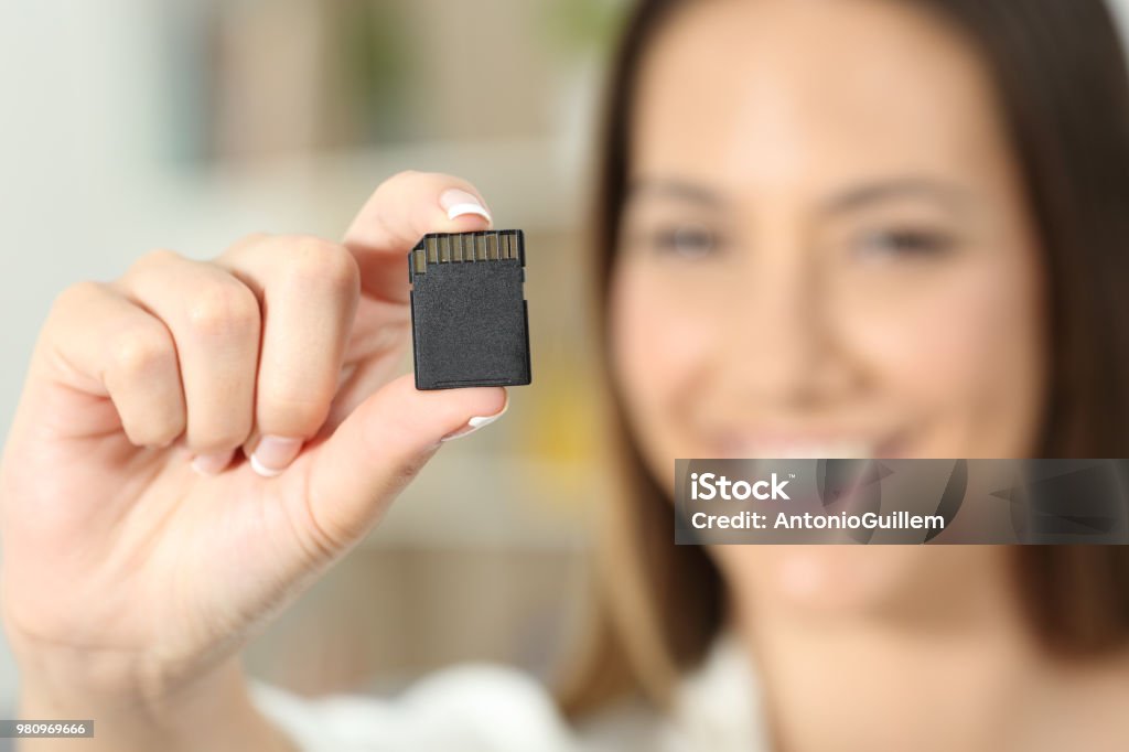 Happy woman hand showing a memory card Close up of a happy woman hand showing a memory card Memory Card Stock Photo