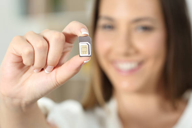 Happy woman hand holding a sim card