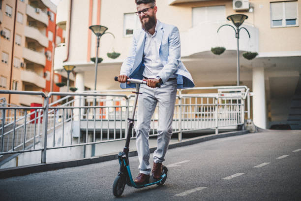 istock Businessman Riding Push Scooter 980983040