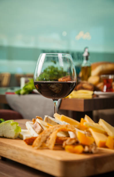 istock Assorted cheese and red wine on wooden platter 980986912