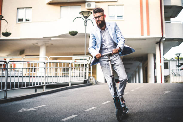 istock Young handsome man riding push scooter 980989508