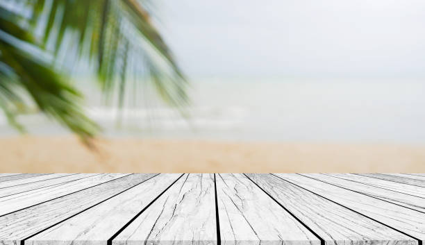 istock abstract blur sea sky nature and coconut's leaves backdrop with old white wood background texture tabletop for show advertise product on display 980989796