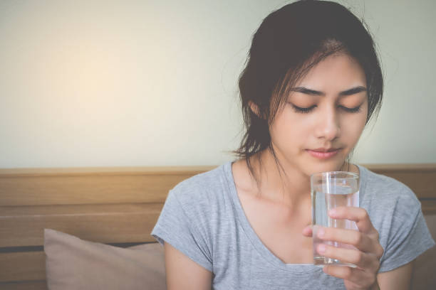 istock Young Woman Drinking Water At Home 980993622