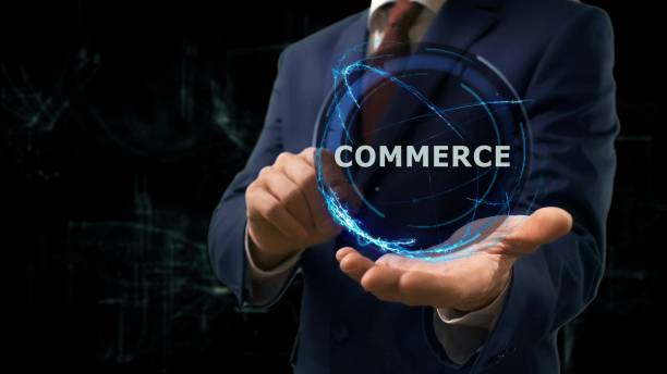 istock Businessman shows concept hologram Commerce on his hand 980996626
