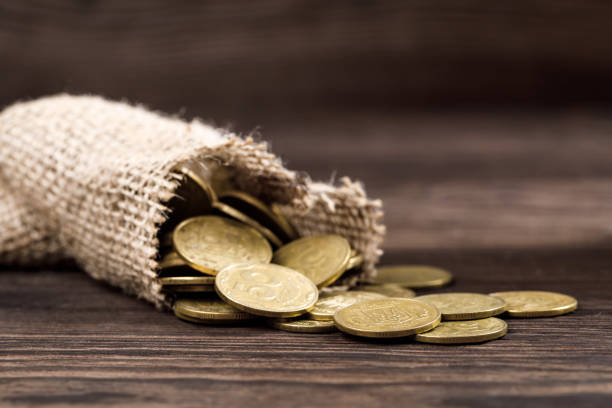 bag of coins bag of coins for money saving and investment bag of coins stock pictures, royalty-free photos & images
