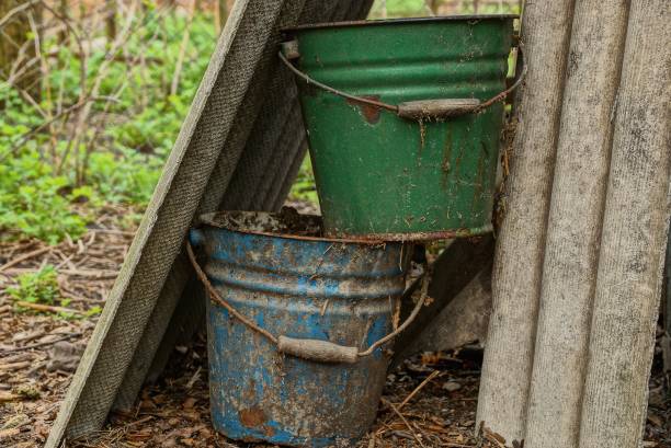 two big old dirty buckets in the garden