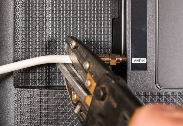 istock Senior man hand cutting the cord on his cable TV package 981006316
