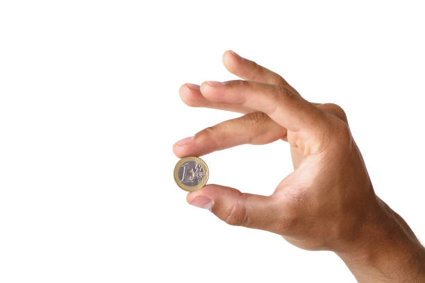 istock man's hand holding euro coin 981008800