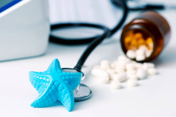 istock starfish and pills on the doctors desk 981015432