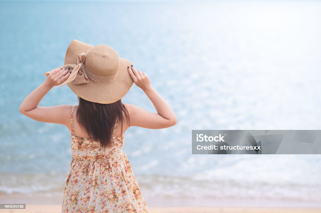Young Asian woman with hat enjoying at the beach. Summer,vacation and holiday concept Adult Stock Photo