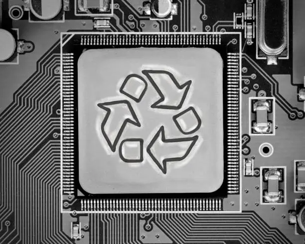 Macro photo of circuit board with recycle sign on the chip surface