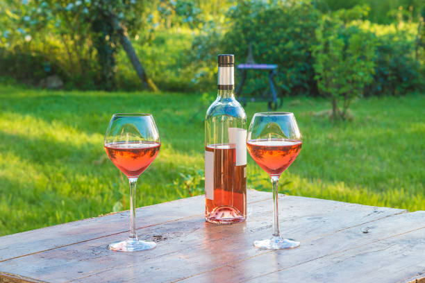 istock Two glasses of pink wine and bottle 981050308