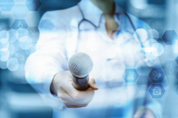 Doctor holds out the microphone .