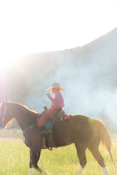 istock Young Boy Rides His Horse Under The Mountains 981054486
