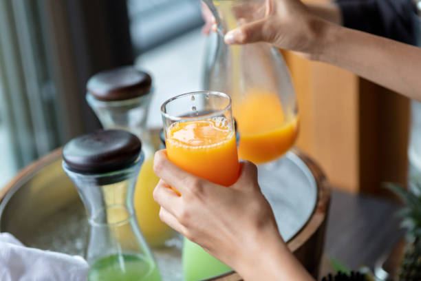 istock Orange juice being poured into a glass 981055002