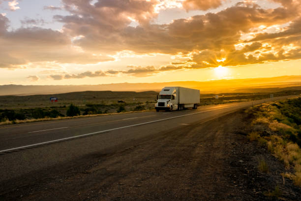 istock Semi-Truck on an Interstate Highway at Dusk with Cloudscape 981057874