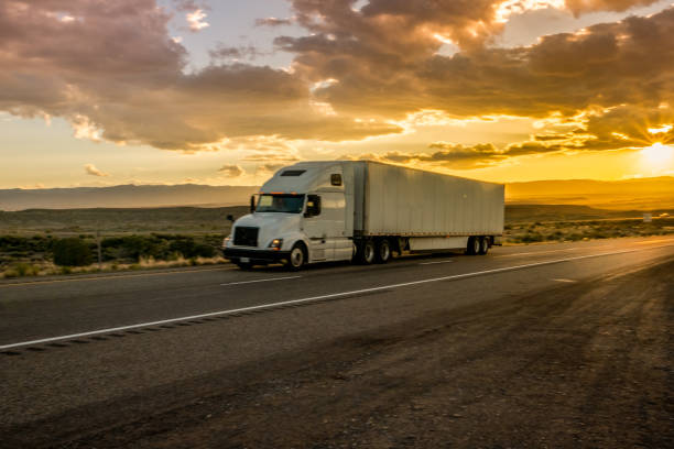 istock Semi-Truck on an Interstate Highway at Dusk with Cloudscape 981057878