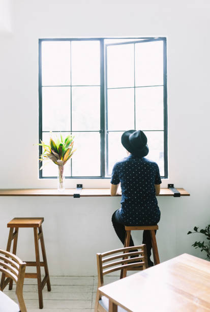 istock Young Man Looking Out Of The Window 981058372