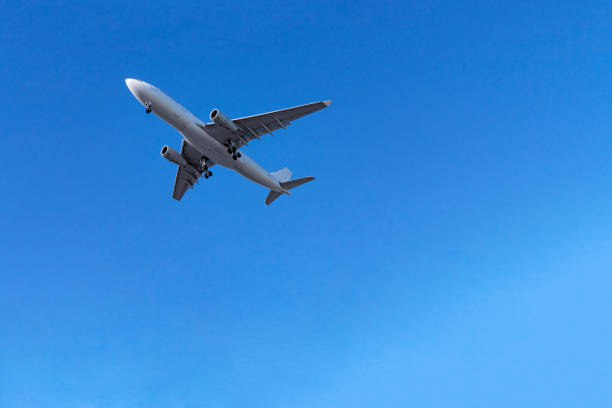 istock airplane in the blue sky 981060738