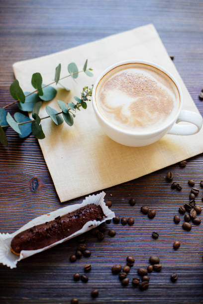istock Cappuccino, eclairs and flowers. 981065940
