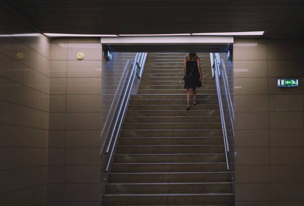 istock Rear View Of Woman Walking On Steps 981066108