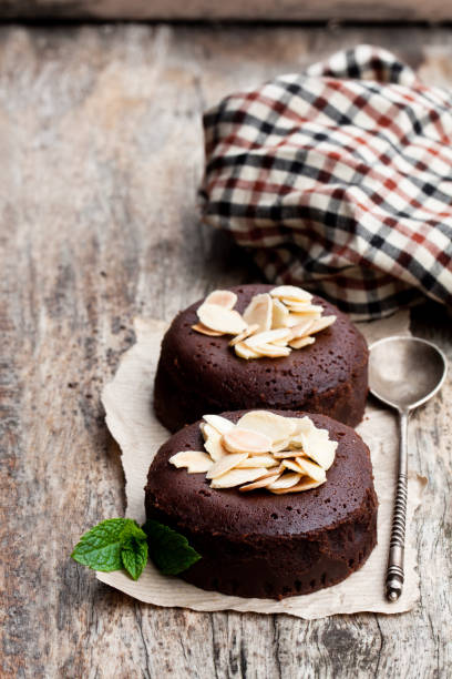 istock Chocolate  fondant with almonds on wooden table 981076056