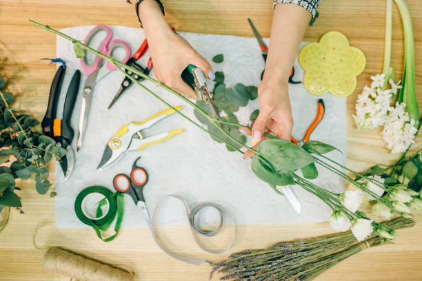 istock Florist prepares flower composition, top view 981076518