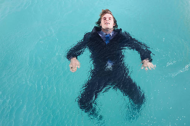 Business man drowning in water , unsuccessful business career