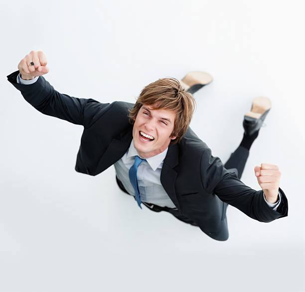 Young business man screaming out success
