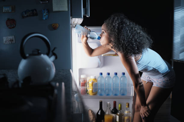 istock Black Woman Sweating And Drinking Water At Night 981088404